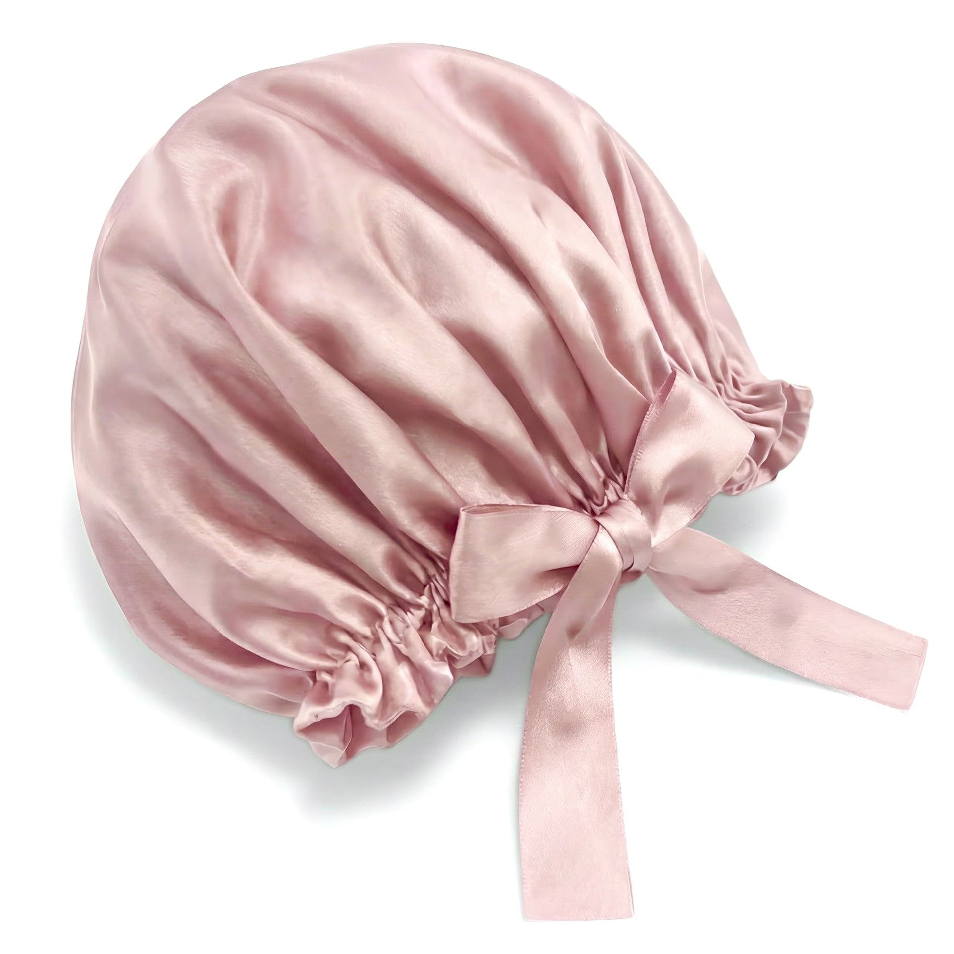 Pink silk bonnet with a ribbon on a white background